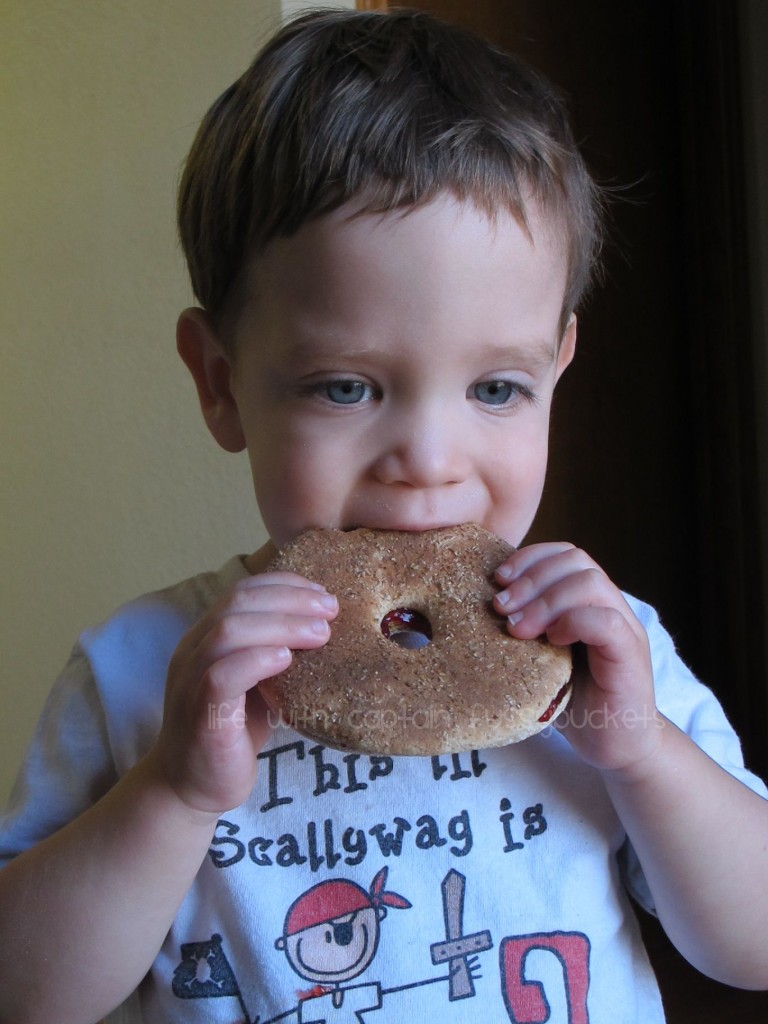 boy eating peanut butter and jelly with chia seeds on a bagel